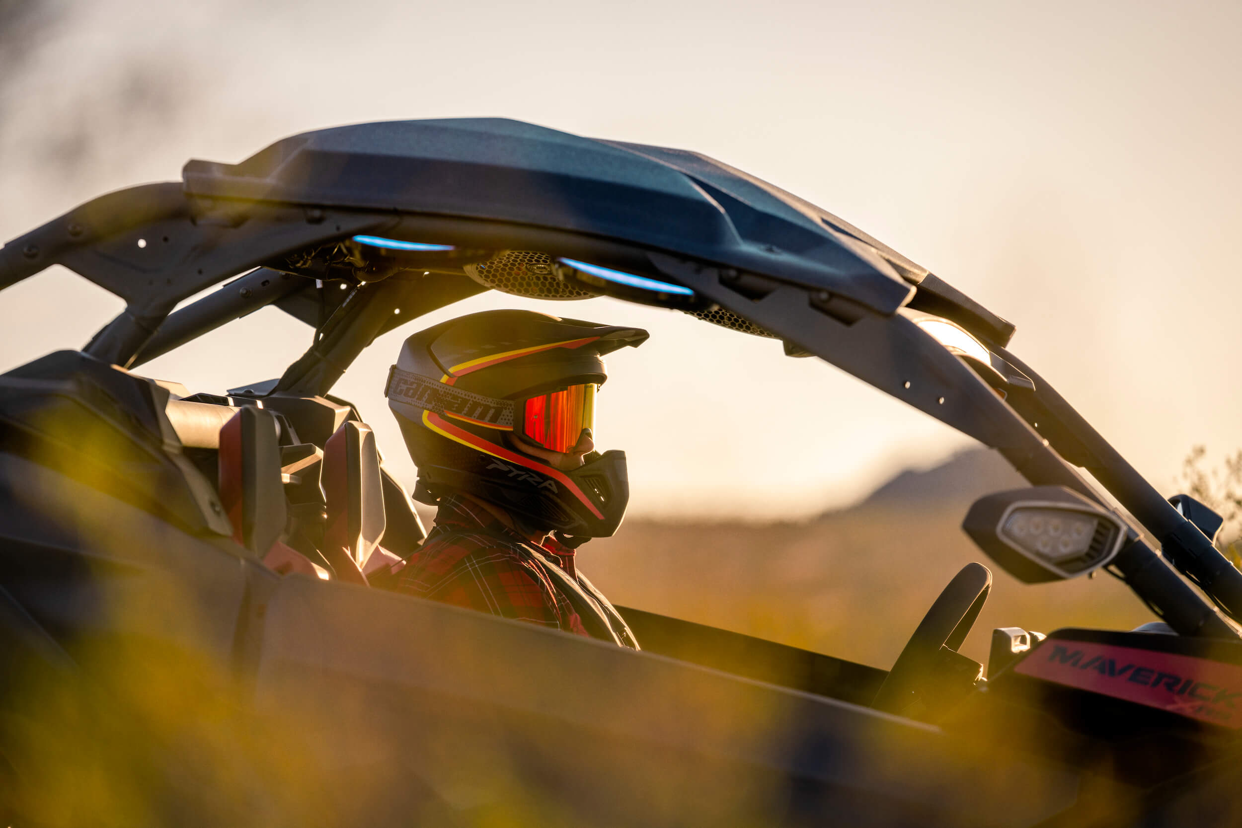 ORV-MY26-MAV-APP-Lifestyle-DSC06873-RGB UTV driver wearing helmet and goggles