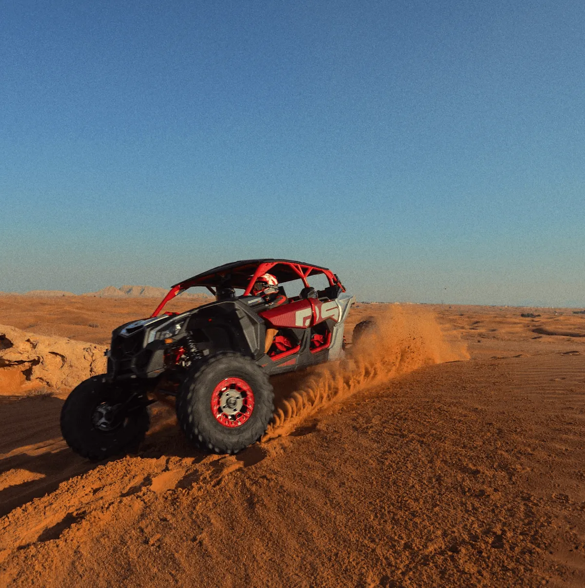 Screen Shot 2026-06-26 at 10.29.24 AM red UTV driving through sand dunes