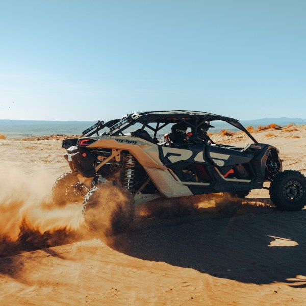 a person sitting on a beach near a body of water