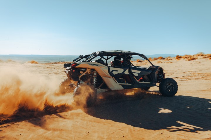 a person sitting on a beach near a body of water