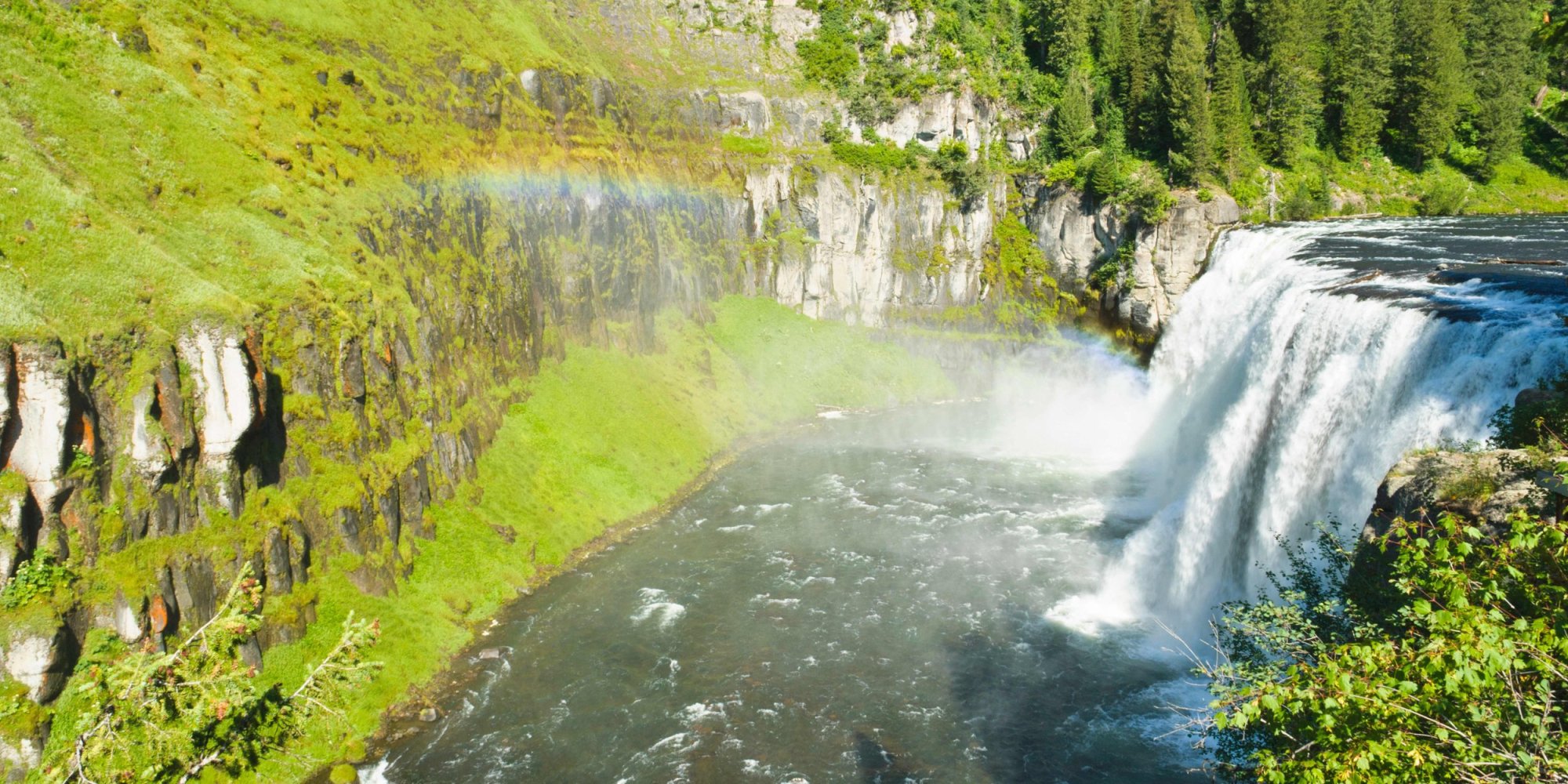 a large waterfall in a forest