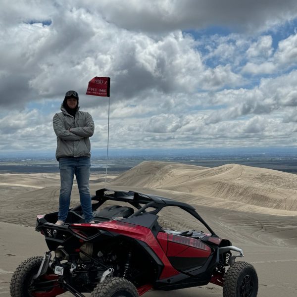 a man riding a motorcycle down a dirt road